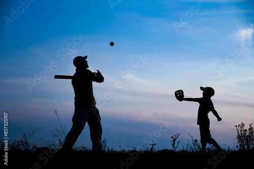 A Happy child with parent playing baseball concept in park in nature