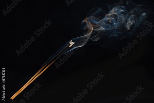 Incense Smoke. Swirling abstract smoke from burning incense stick on black background