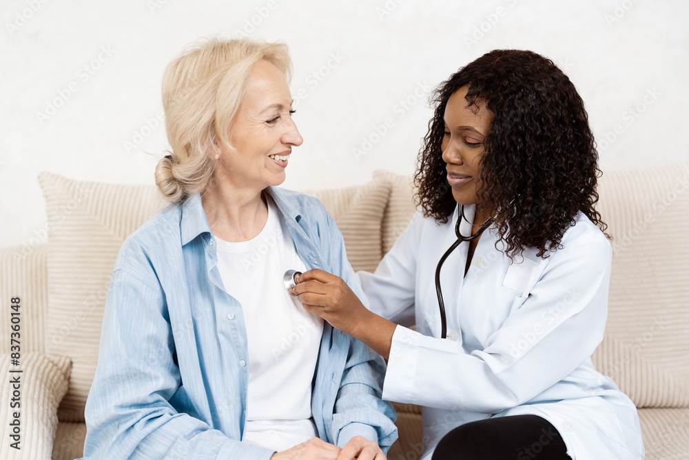 Doctor Performing Health Checkup On Senior Woman At Home Doctor Performing Health Checkup On Senior Woman At Home