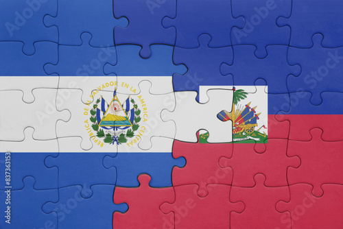 puzzle with the colourful national flag of haiti and flag of el salvador .