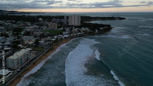 Wallpaper Mural aerial view of luquillo puerto rico skyline with waves crashing on the beach (tropical caribbean island town at sunset, dusk) night time tall hotel apartment buildings sand sea ocean paradise Torontodigital.ca