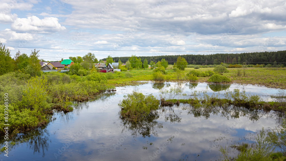 A majestic river winds its way through a dense, vibrant green forest, creating a mesmerizing scene of natures beauty and tranquility