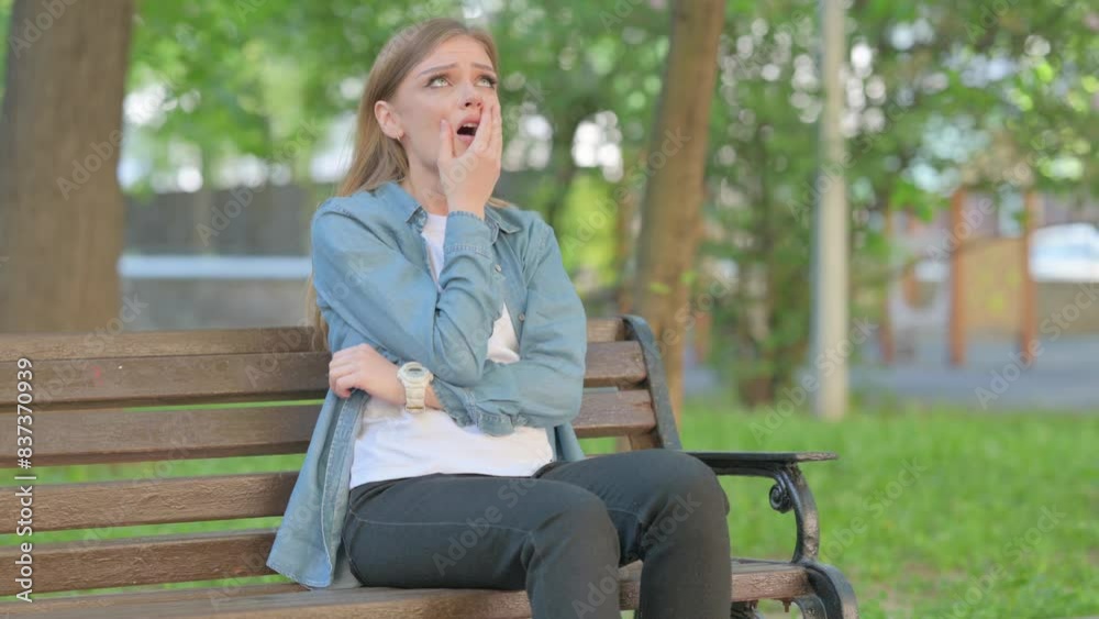 Depressed Outdoor Sitting Young Woman having Headache, Migraine Depressed Outdoor Sitting Young Woman having Headache, Migraine
