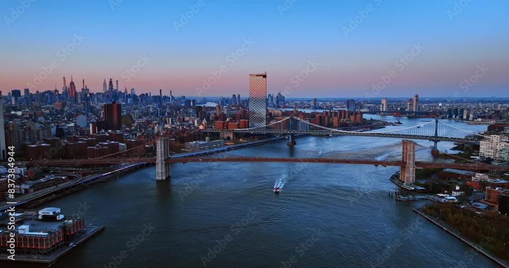 View on the Manhattan Bridge and the Brooklyn Bridge on the East River. New York scenery at twilight time. Aerial perspective. View on the Manhattan Bridge and the Brooklyn Bridge on the East River. New York scenery at twilight time. Aerial perspective.