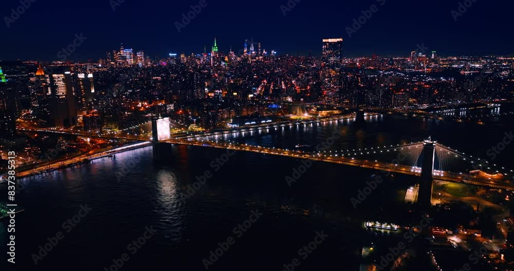 Glamorous panorama of New York at night. Millions of lights illuminate gorgeous city. Drone footage above the East River. Glamorous panorama of New York at night. Millions of lights illuminate gorgeous city. Drone footage above the East River.