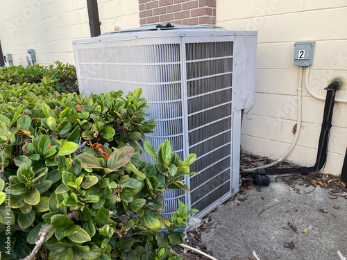 Air conditioner unit exterior side view wall outlet and bush