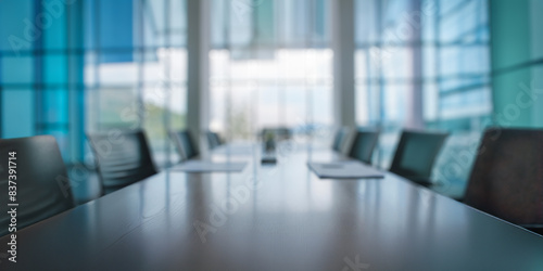 Defocussed, blurred background of a meeting room in a modern bright office with large windows. © Barry