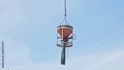 Concrete Funnel Skip for Aiming and Placing Concrete Lifted with Crane over Construction Site