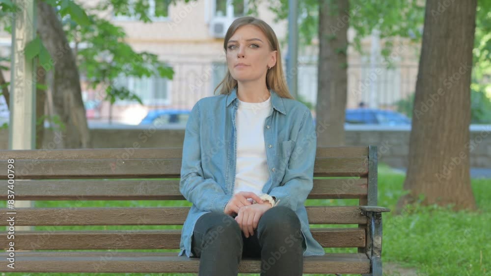 Waiting Young Woman Checking Time while Sitting on Bench in Park