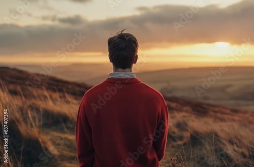 Man in red sweater looking at sunset © Victoria