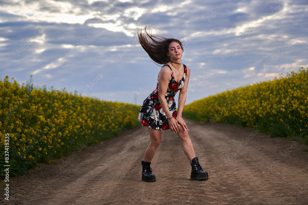 Fototapeta premium Beautiful woman in canola field