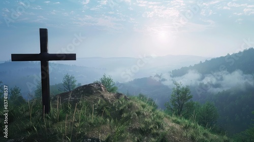 A simple wooden cross on a hill, overlooking a peaceful countryside photo