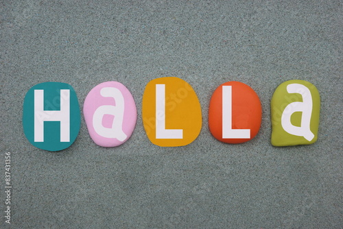 Halla is a feminine given name and a surname composed with multi colored stone letters over green sand