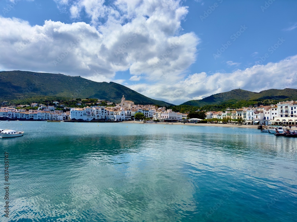 view over the Badia de Cadaqués, to the beautiful  white houses of Cadaqués, Port Alguer and the turquoise water of the Mediterranean Sea, mountains of the Pyrenees behind, Girona, Catalonia, Spain