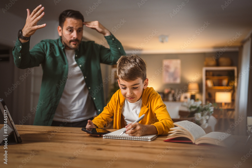 Fototapeta premium Angry father yell at his son to do homework as soon as possible