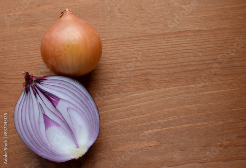Red onions on a rustic wooden background. Copy space.