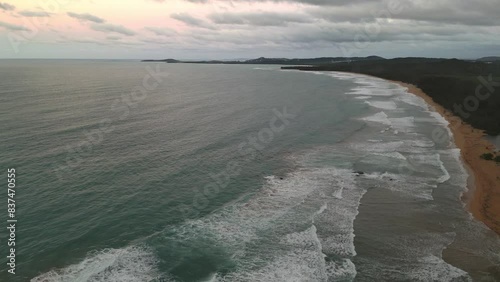 waves crashing on the shoreline of tropical island paradise vacation travel tourism destination (luquillo, puerto rico) sand wave beach shore (sunset, dusk, night time, getaway) aerial drone footage photo