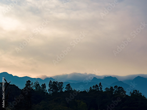 Soft clouds formations float over the Iguaque mountain, in the eastern Andean highlands of central Colombia, illuminated by the sunrise light. photo