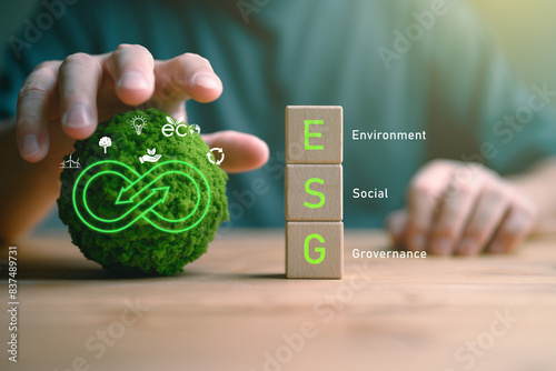 Businessman holding globe with ESG icon green earth concept for environment Society and Governance sustainable environmental concept of the world, green business natural environment. Save earth.