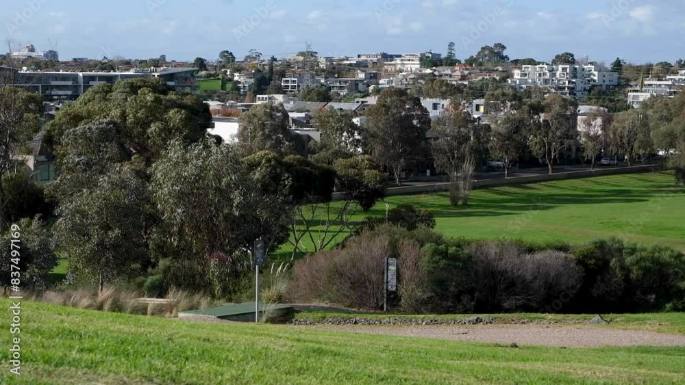 Elevated view of the skyline of a suburban neighborhood with many houses, a large public outdoor park with grass ground for recreational activities and sports. Maribyrnong, Melbourne VIC Australia. Elevated view of the skyline of a suburban neighborhood with many houses, a large public outdoor park with grass ground for recreational activities and sports. Maribyrnong, Melbourne VIC Australia.