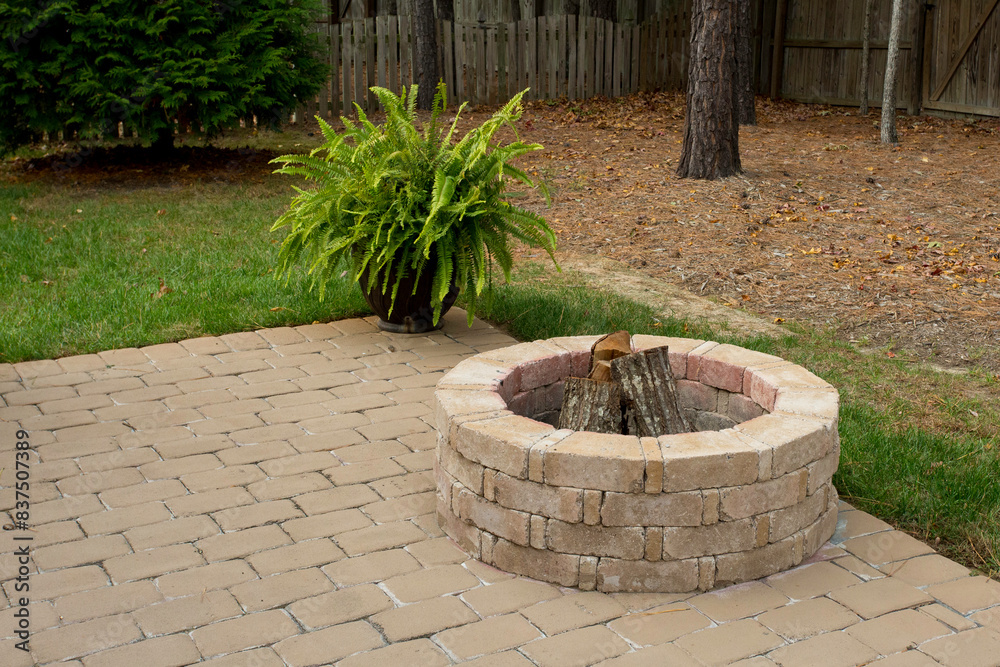 Cozy Backyard Patio with Fire Pit and Greenery
