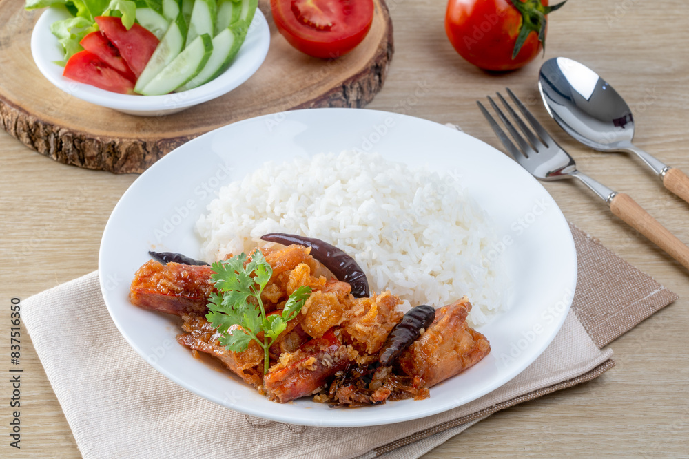 Shrimp with sauce over rice on the wooden table