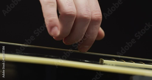 Close-up - Finger plucking classical guitar string photo