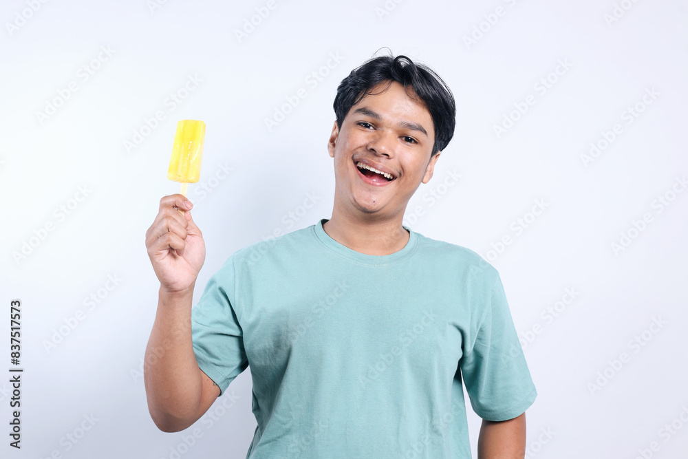 Potrait Of Excited Asian Man Showing Ice Cream Stick For Ads Isolated On White Background Potrait Of Excited Asian Man Showing Ice Cream Stick For Ads Isolated On White Background