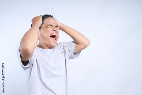 Fotografie Annoyed Young Asian Guy Showing Defeat Gesture For Advertisement Isolated On Whi