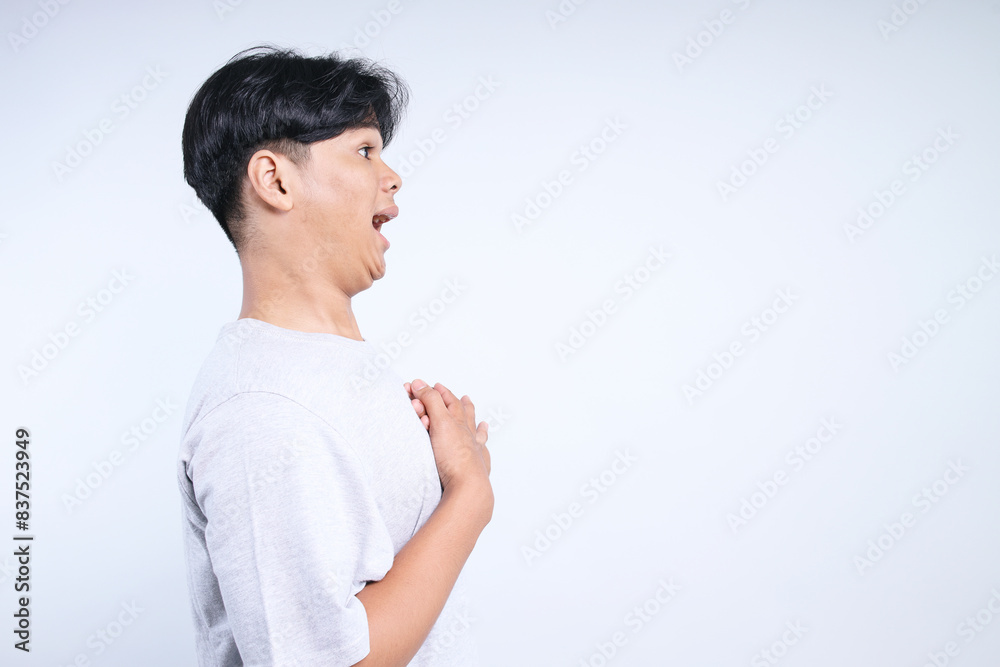 Side View Of Young Asian Guy Suprised To Free Space For Ads Isolated On White Background Side View Of Young Asian Guy Suprised To Free Space For Ads Isolated On White Background