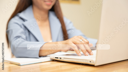 Businesswoman uses hands on keyboard to search for financial and educational information. Search learning concept For business and education
