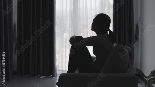 Silhouette of a woman who is stressed and suffering from depression alone. Anxiety young woman Despair and stress. Lonely and unhappy female are social victims. loneliness youth in home.