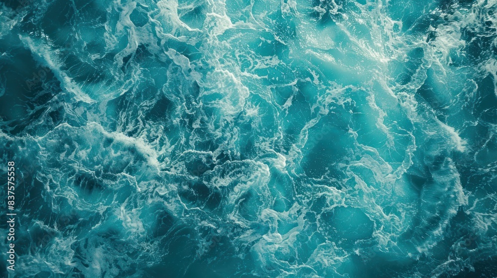 Fototapeta premium Turquoise foam surface of the blue sea with waves The water surface is blue foam.