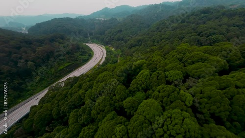 An aerial FPV establish shots over Rawang Serendah Highway or Rawang Bypass. A nature preserve green sustainable winding road Highway 2.7km length