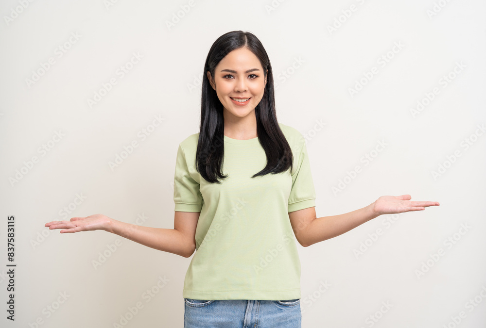 Beautiful smiling happy young asian woman in green shirt. Charming female lady open hands palm up holding something on isolated white background. Asian woman cute Pretty people looking blank space. Beautiful smiling happy young asian woman in green shirt. Charming female lady open hands palm up holding something on isolated white background. Asian woman cute Pretty people looking blank space.