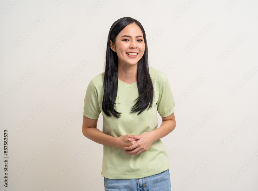 Beautiful smiling happy young asian woman age around 25 in green shirt. Charming female lady standing pose on isolated white background. Asian woman people laughing confident with backdrop.