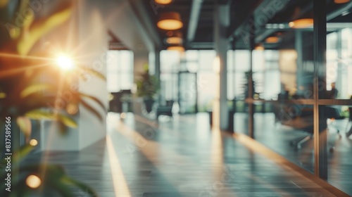 A bright sun shines through the window of a modern office building  casting a warm glow on the sleek  tiled floor.