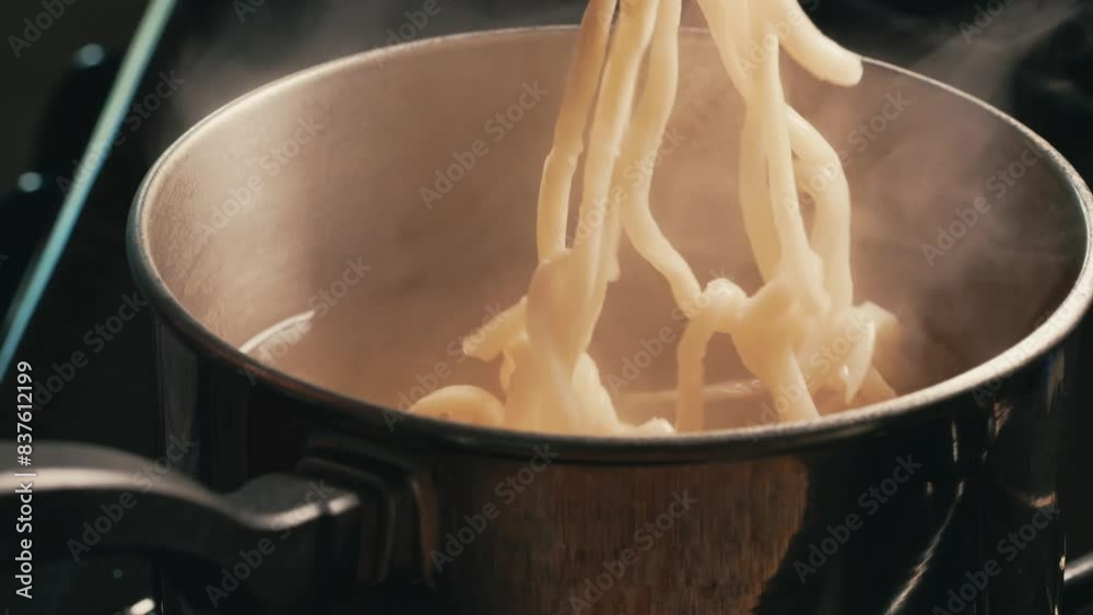 udon noodles cooking with fork 