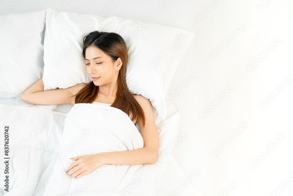 Beautiful asian woman lying in the bed . Young woman sleeping well in comfortable cozy fresh bed on soft pillow white linen. Morning in the bedroom. Health and rest concept. Beautiful asian woman lying in the bed . Young woman sleeping well in comfortable cozy fresh bed on soft pillow white linen. Morning in the bedroom. Health and rest concept.