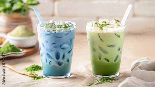 Trendy green and blue matcha drink in a glass with ice and a straw. Colorful Japanese tea latte, green and blue moon milk. Tea made from dried butterfly pea flowers and tea tree leaves with milk