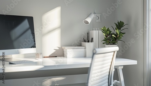 A white desk with a computer monitor, a chair, and a potted plant