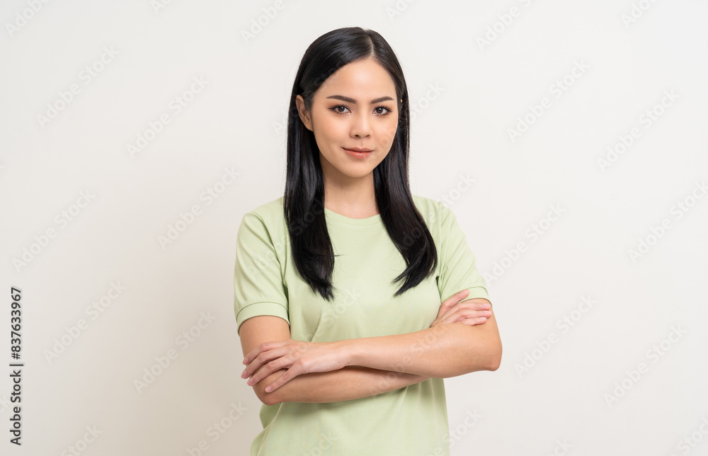 Beautiful smiling happy young asian woman age around 25 in green shirt. Charming female lady standing pose on isolated white background. Asian woman people arms crossed confident with backdrop. Beautiful smiling happy young asian woman age around 25 in green shirt. Charming female lady standing pose on isolated white background. Asian woman people arms crossed confident with backdrop.