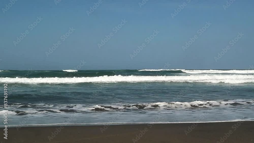 The atmosphere of the waves on the beach on a sunny day, when dawn breaks at Parangtritis Beach Yogyakarta Indonesia The atmosphere of the waves on the beach on a sunny day, when dawn breaks at Parangtritis Beach Yogyakarta Indonesia