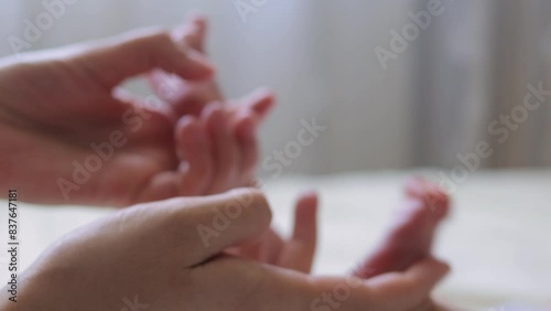 Wallpaper Mural Adorable little boy lying on bed as unrecognizable mother massages his tiny feet caring for her newborn with maternal love Torontodigital.ca