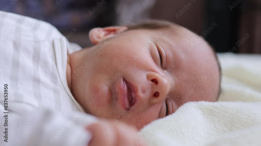 Tiny and fragile infant resting peacefully his tiny chest rising and falling with each breath baby looking angelic while lying alone on bed Tiny and fragile infant resting peacefully his tiny chest rising and falling with each breath baby looking angelic while lying alone on bed