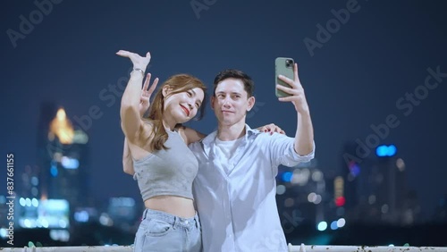 Shot of two diverse couples taking selfies together with night city urban view, date night memories, enjoy travel inside big city, happy urban couples taking photos together city night light vibes