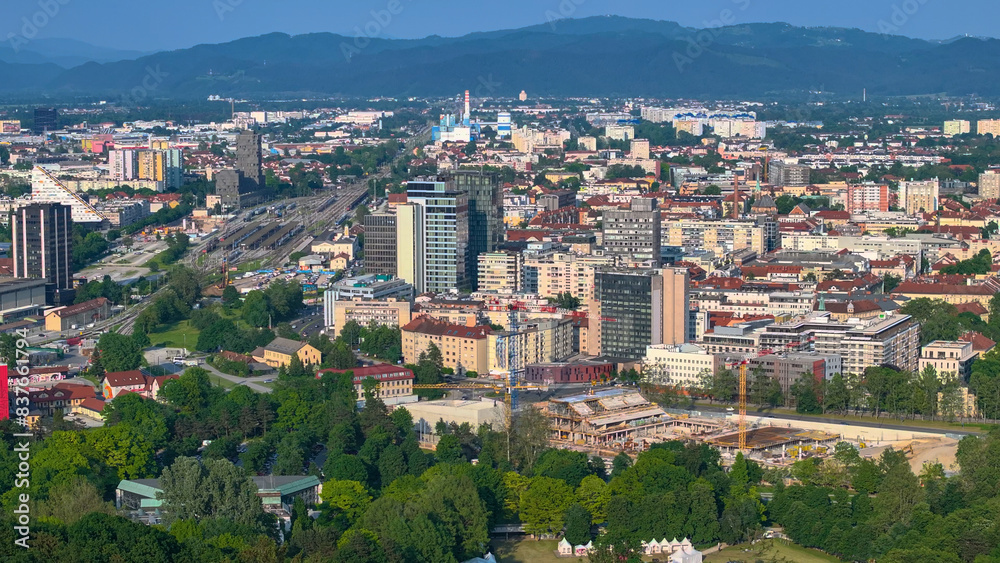 AERIAL: Developing part of Ljubljana with a large construction site and railway.