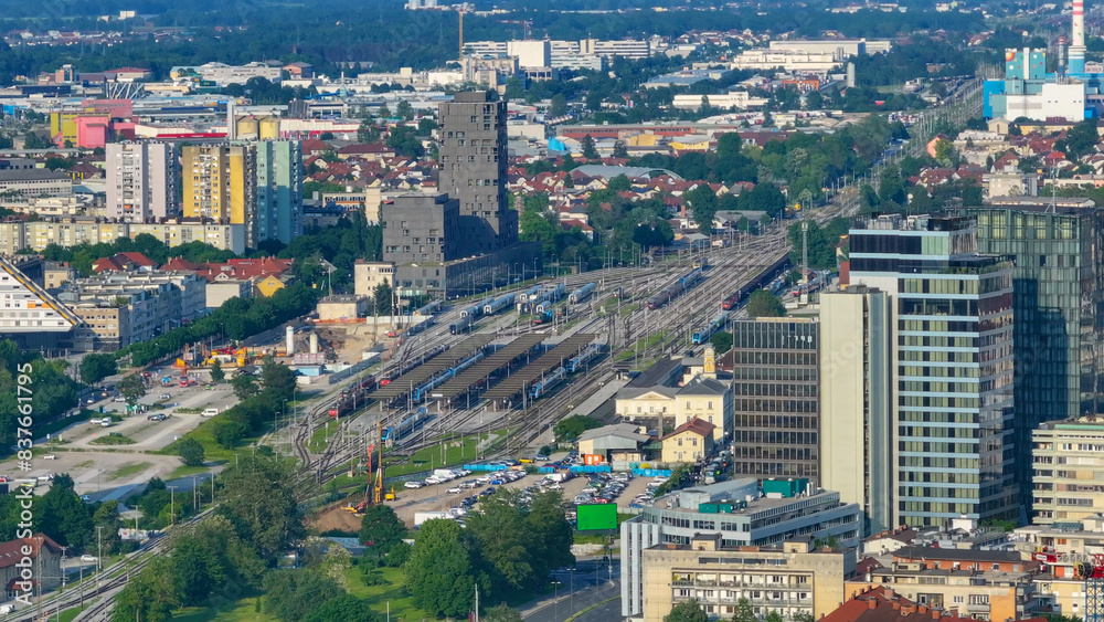 Fototapeta premium AERIAL: Railway station lies in middle of residential neighborhood in Ljubljana