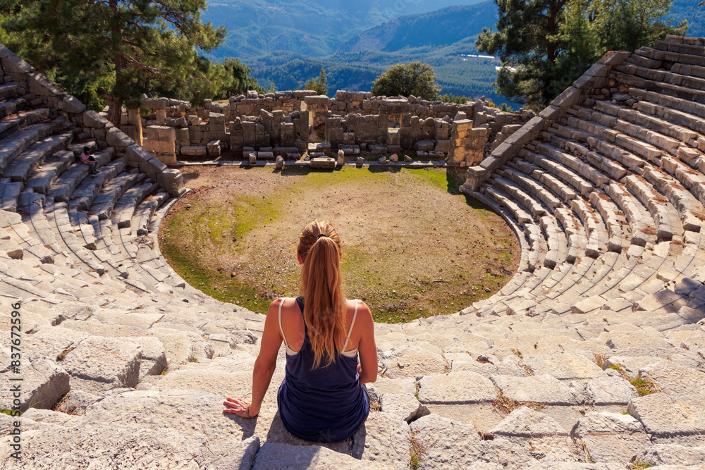 Fototapeta premium Traveler woman sitting in amphitheatre in Turkey- Antalya, Arykanda