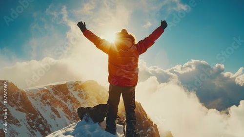 Triumphant Individual Celebrating Accomplishment Atop Majestic Mountain Peak with Breathtaking Panoramic Scenery photo